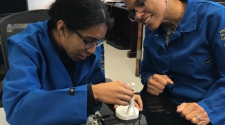 Dr-Poe-assisting-grad-student-in-Poe-Lab Dr Poe assisting Grad Student in Poe Lab 3x2