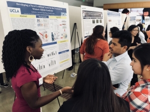 MARC student explaining research poster